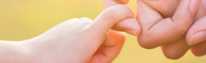 kid and parent holding hands