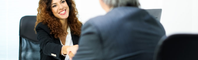 Business people shaking their hands in an office